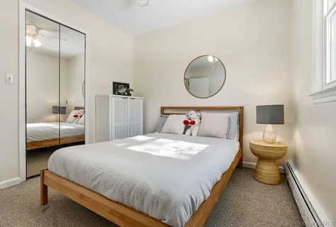 a bedroom with a bed and a mirror