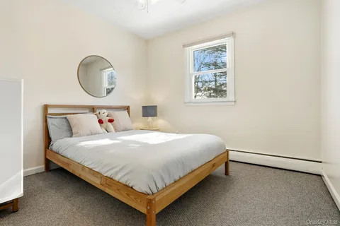 a bedroom with a bed flowerpot and a window