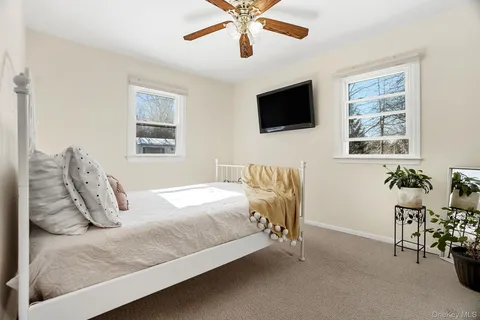 a bedroom with a bed a couch and a window