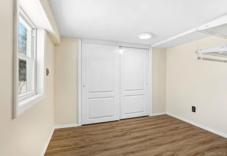 a view of a room with wooden floor and bathroom