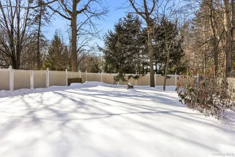 a view of fountain with large trees