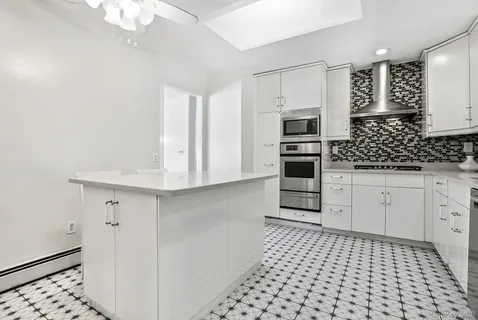 a kitchen with granite countertop a stove and a microwave