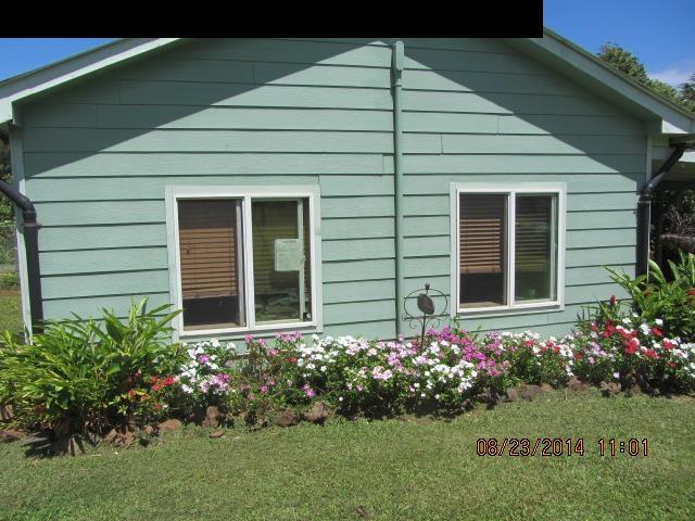 779 Mopua Street Haiku, HI 96708 - Photo 7 of 16 a house with a flower garden in front of it
