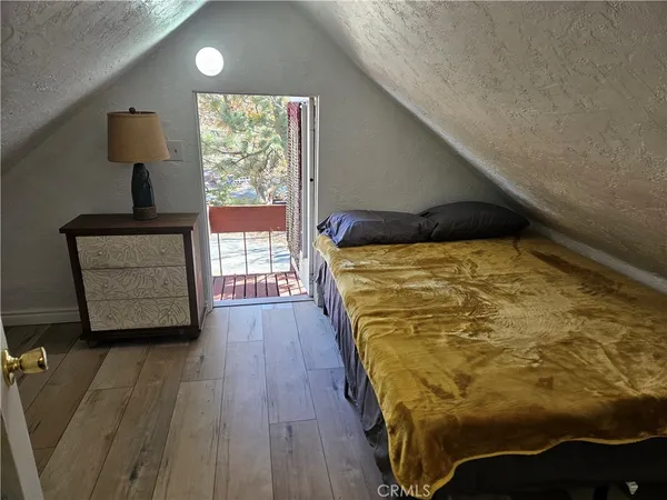 a bed sitting in a bedroom next to a window