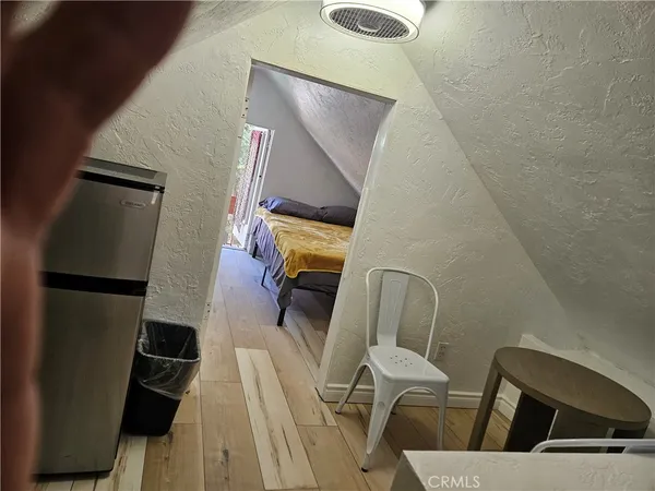 a view of living room with furniture and wooden floor