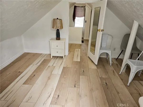 a view of living room with furniture and wooden floor