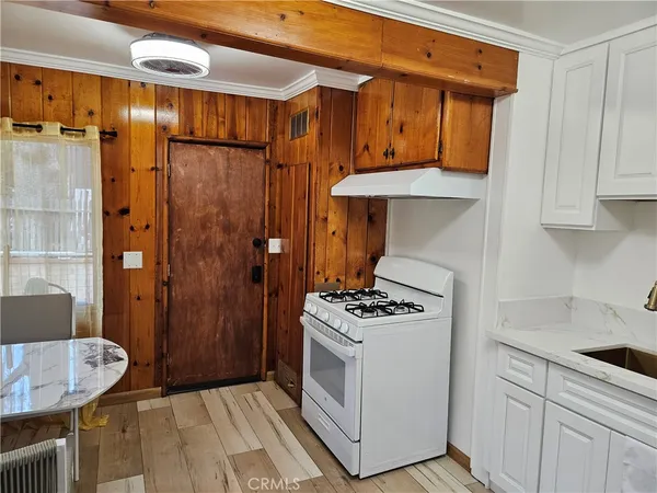 a kitchen with stainless steel appliances wooden cabinets and a stove top oven