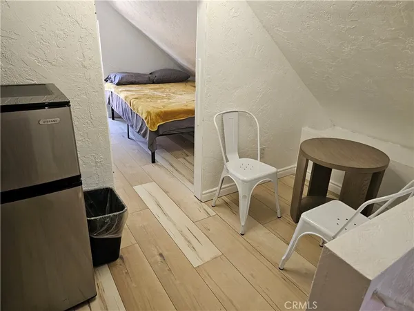 a room with a chair and white walls