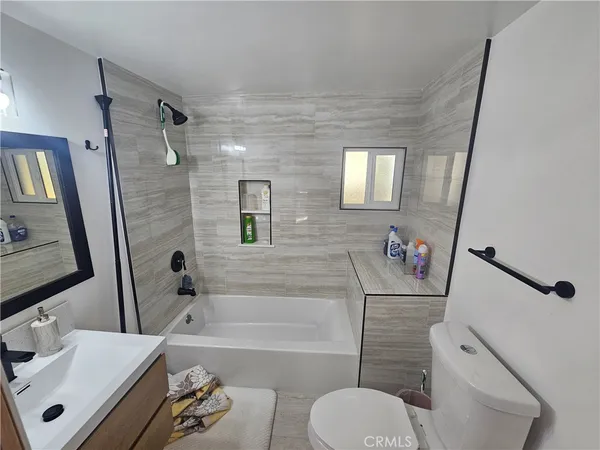 a bathroom with a sink toilet a mirror and shower