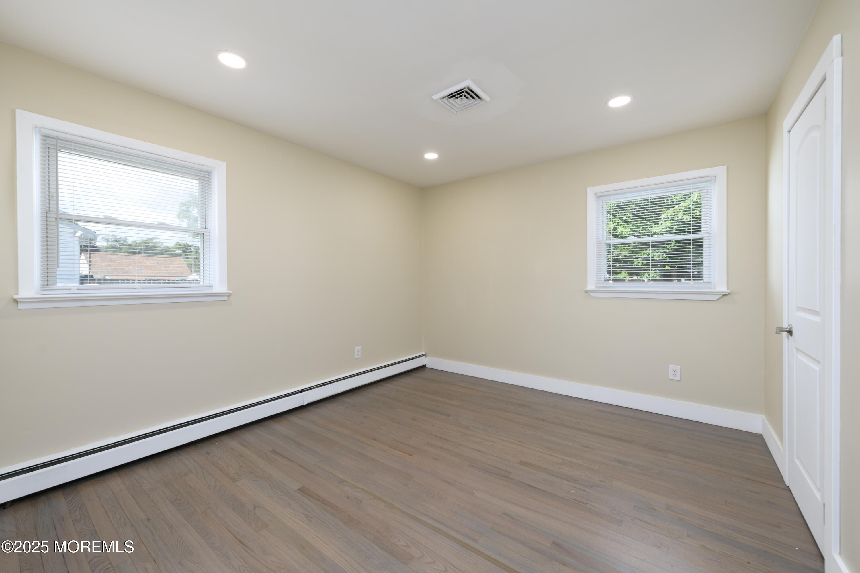 422 Maple Drive Belford, NJ 07718 - Photo 20 of 55 an empty room with wooden floor and windows