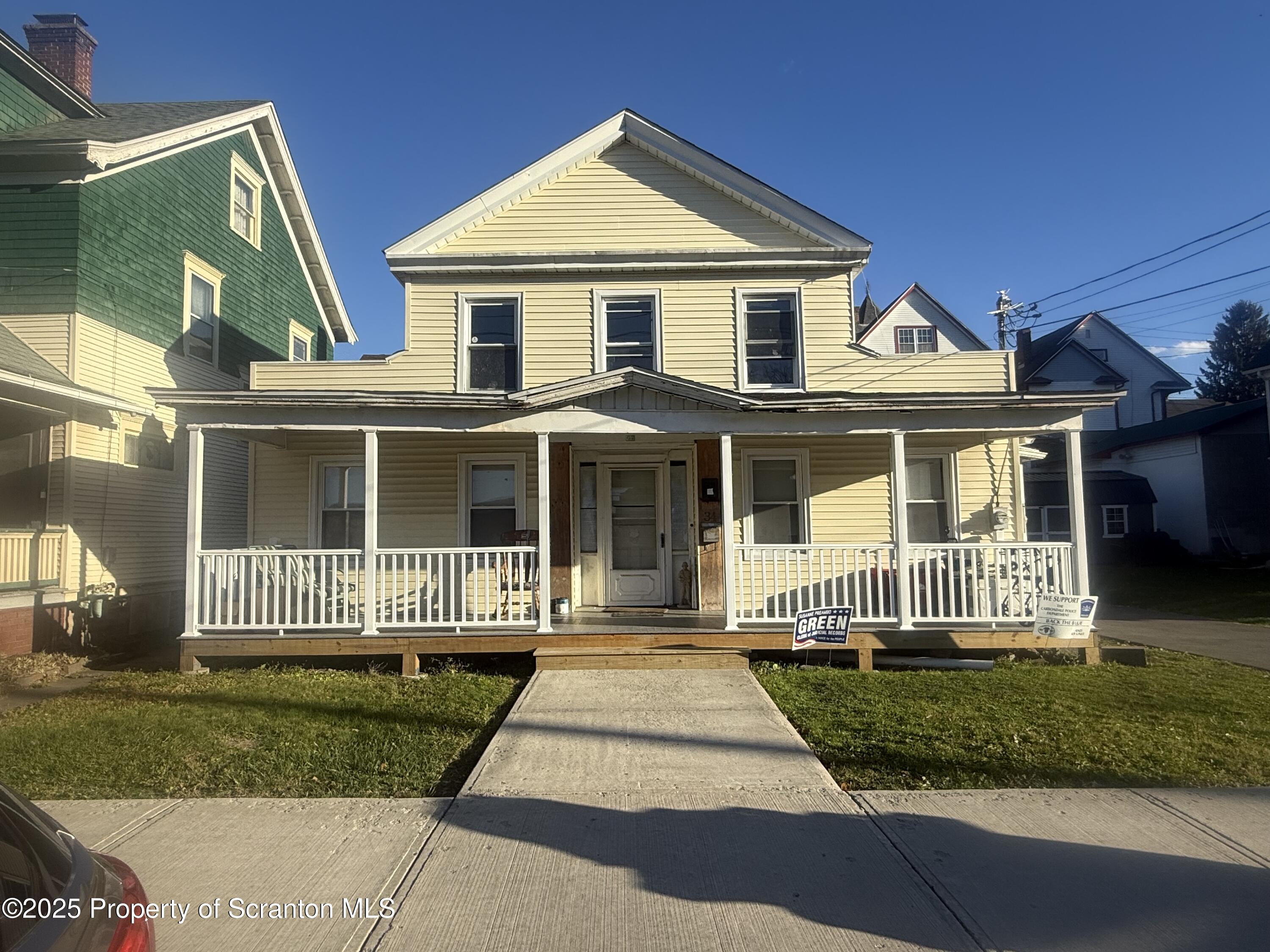 a front view of a house with a garden and porch