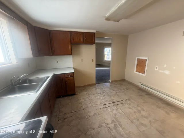 a kitchen with a refrigerator and a sink