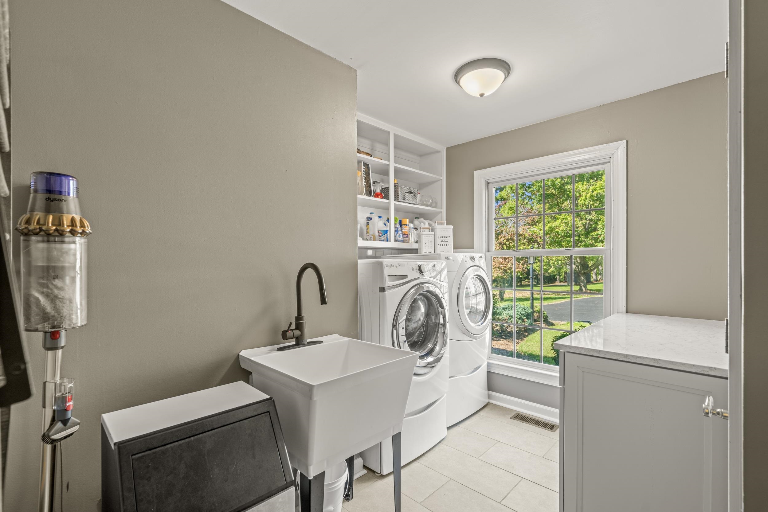 1109 Ross Road Lexington, VA 24450 - Photo 33 of 71 a kitchen with a sink a washer and dryer next to a window