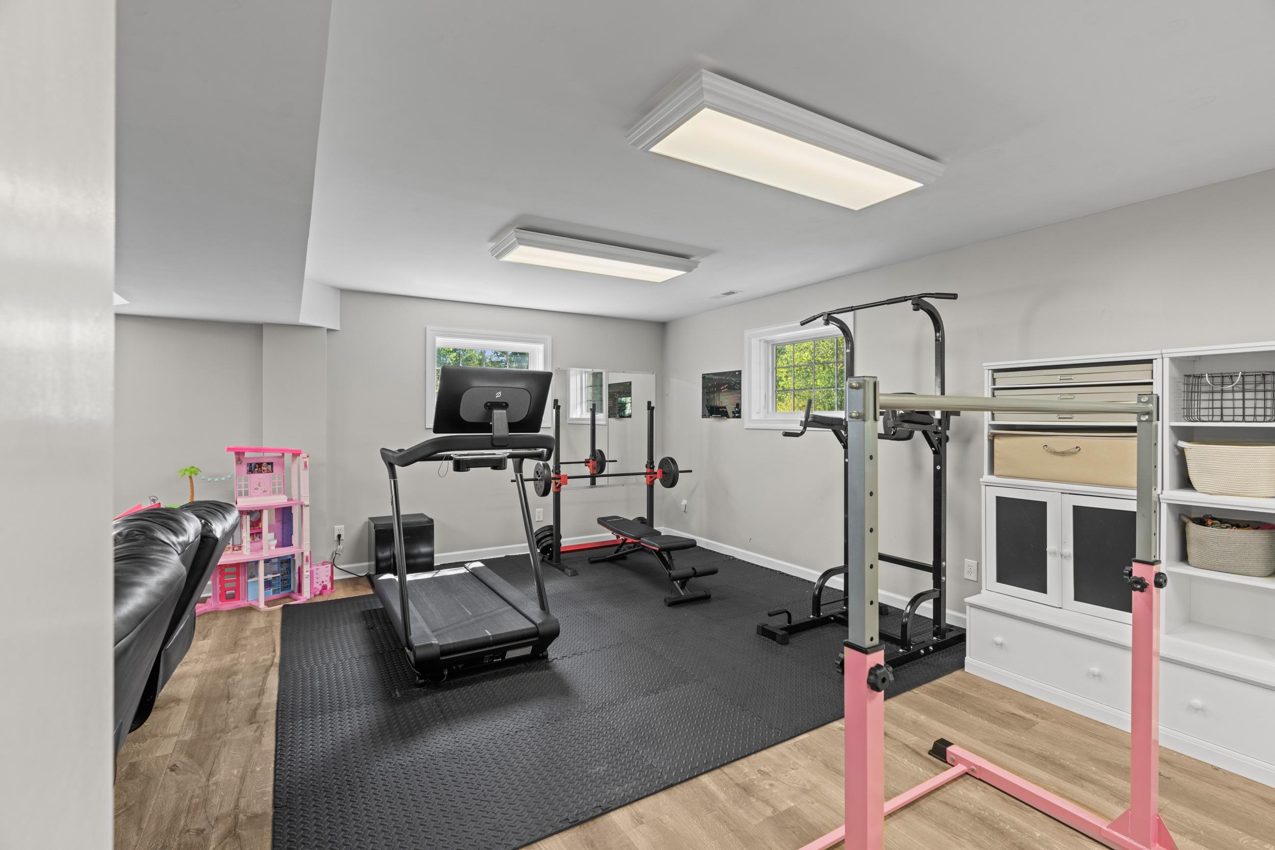 1109 Ross Road Lexington, VA 24450 - Photo 47 of 71 a room with gym equipment and a flat screen tv