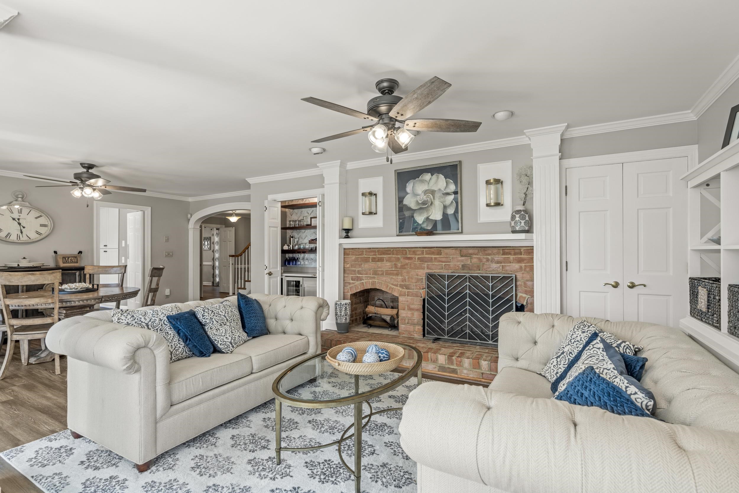 1109 Ross Road Lexington, VA 24450 - Photo 8 of 71 a living room with furniture a fireplace and a chandelier