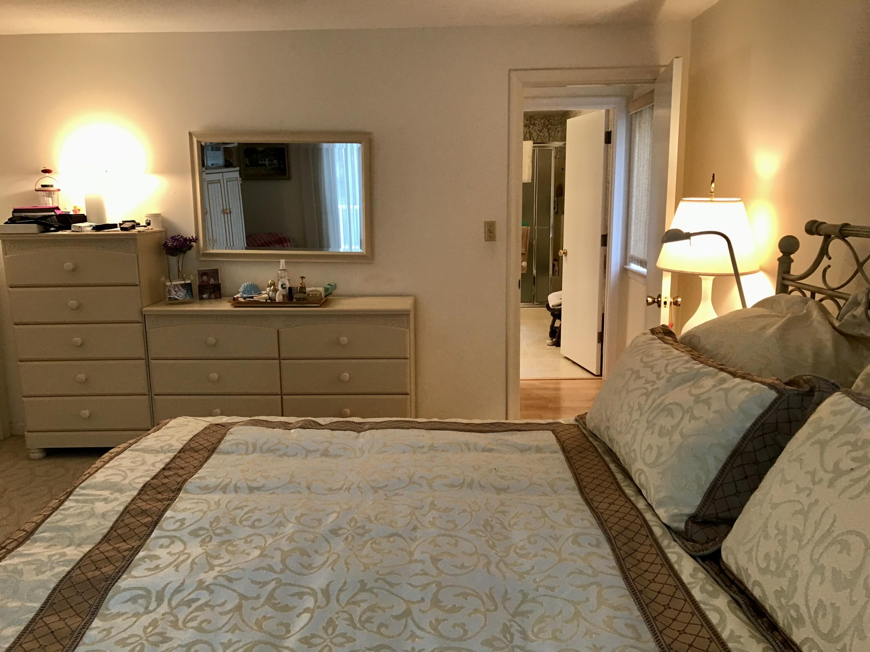 17 The Morgan Circle Mashpee, MA 02649 - Photo 34 of 49 a bedroom with a large bed and a mirror