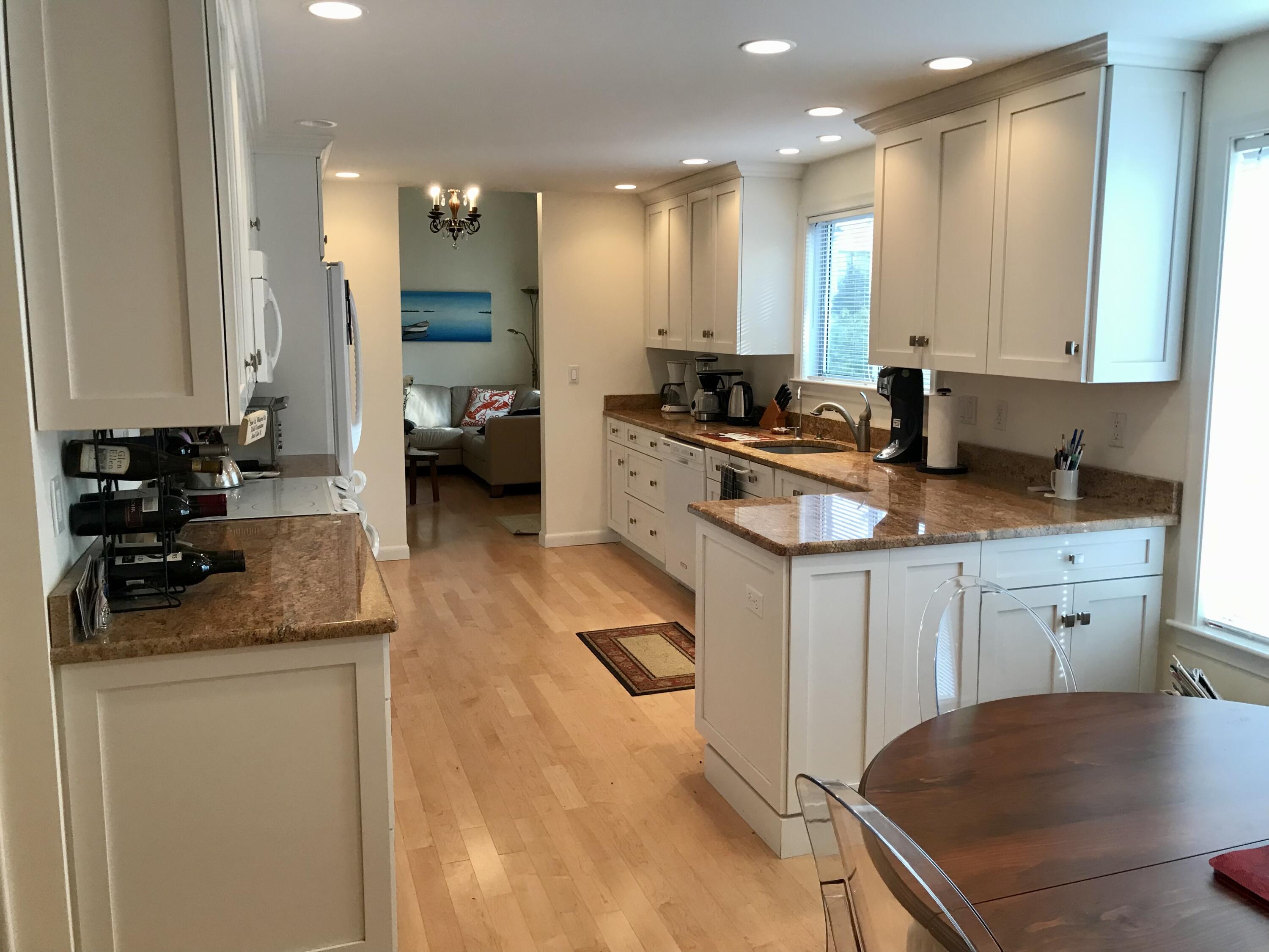 17 The Morgan Circle Mashpee, MA 02649 - Photo 4 of 49 a kitchen with a sink stove and cabinets