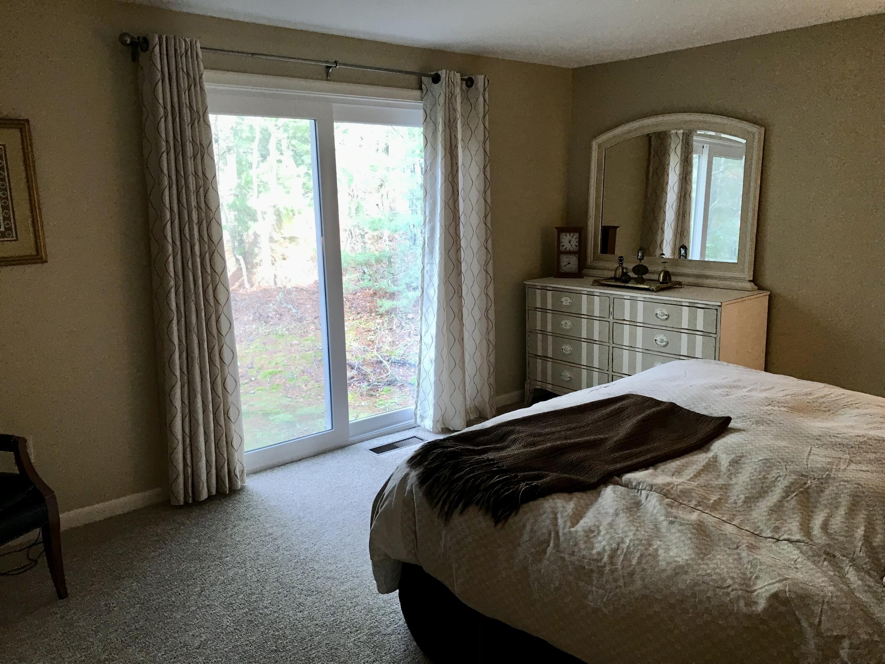 17 The Morgan Circle Mashpee, MA 02649 - Photo 43 of 49 a bedroom with a bed and a mirror