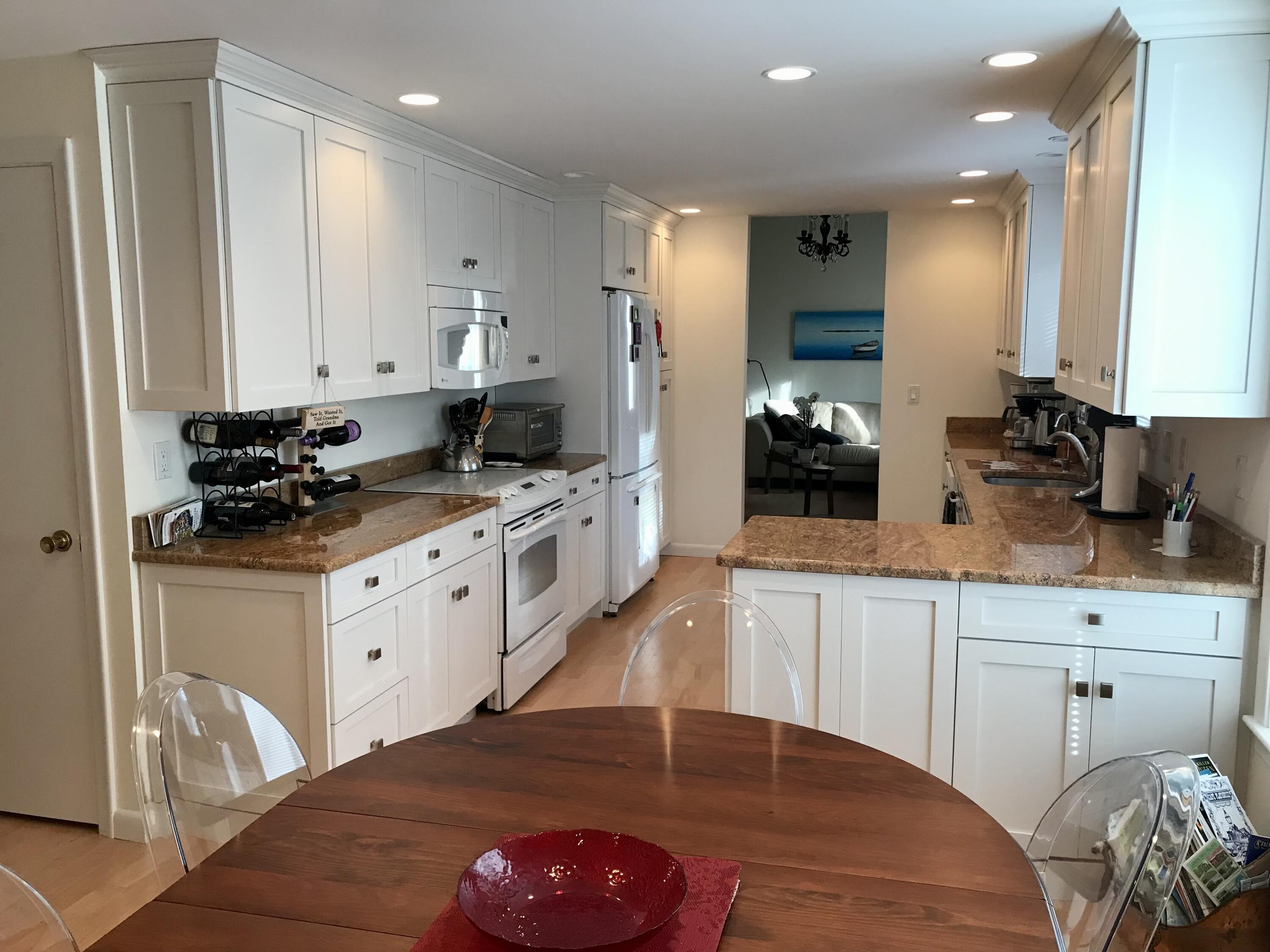 17 The Morgan Circle Mashpee, MA 02649 - Photo 6 of 49 a kitchen with stainless steel appliances a sink stove and cabinets