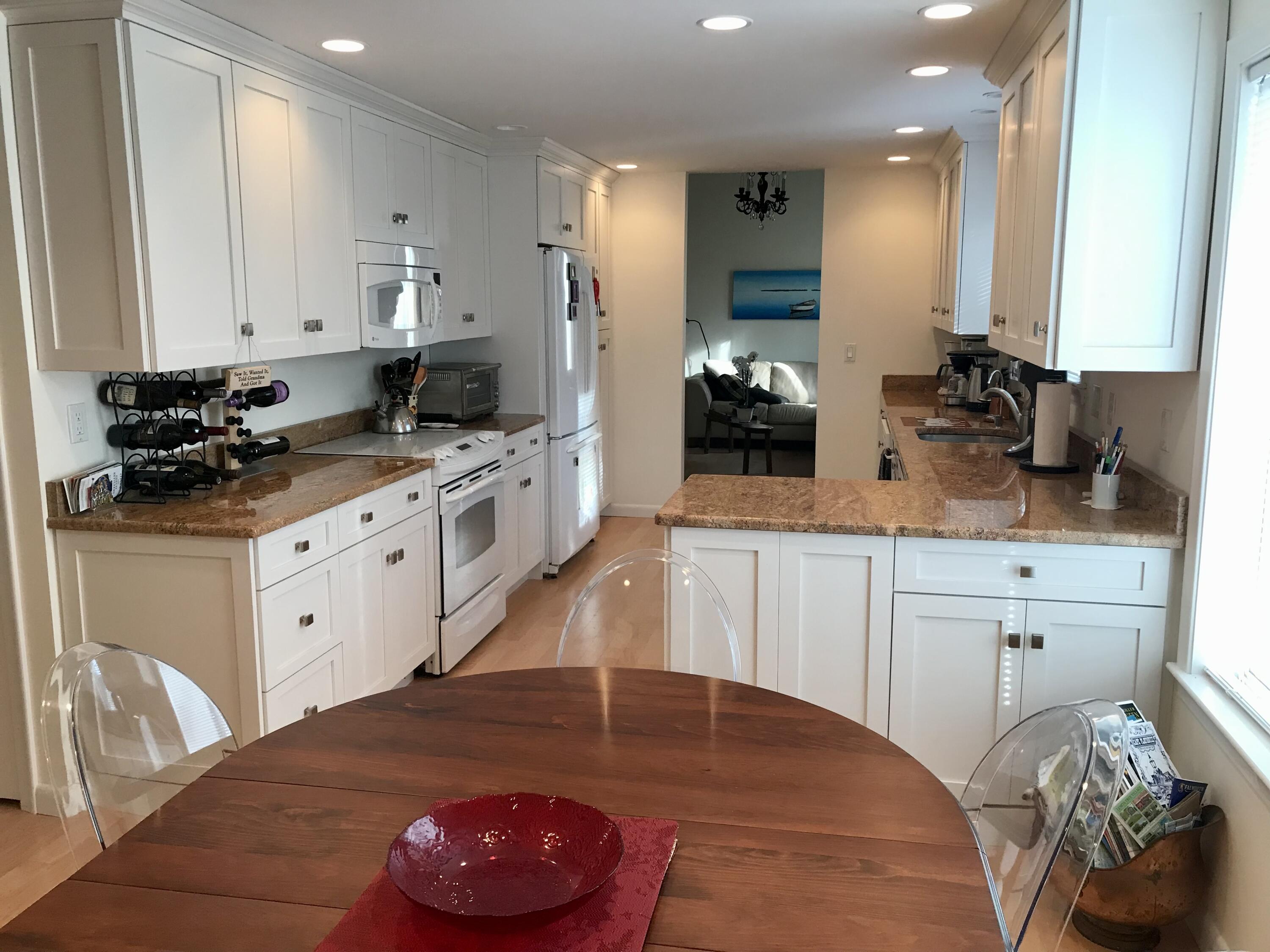 17 The Morgan Circle Mashpee, MA 02649 - Photo 8 of 49 a kitchen with a sink stove and cabinets