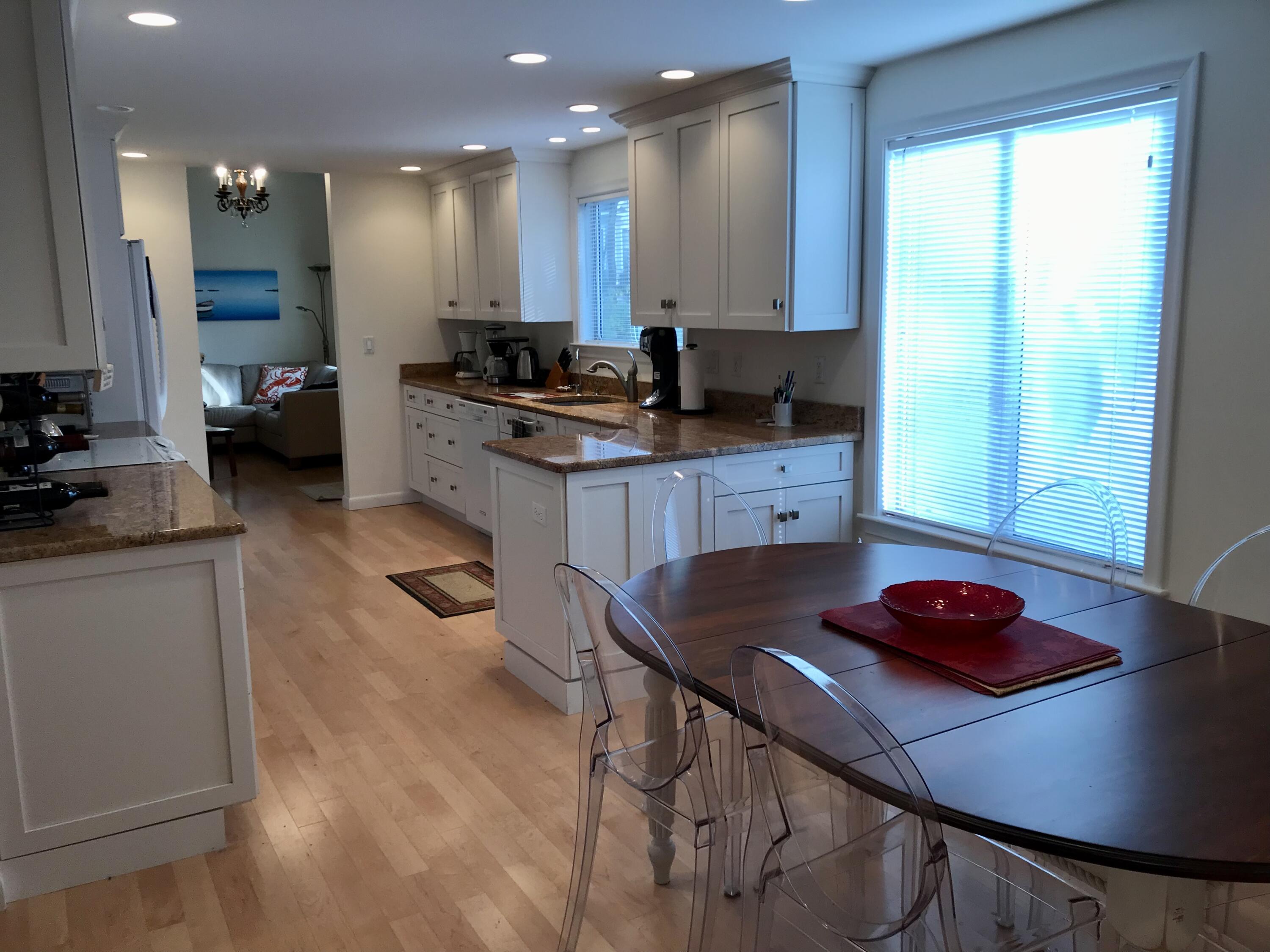 17 The Morgan Circle Mashpee, MA 02649 - Photo 9 of 49 a kitchen with stainless steel appliances granite countertop a sink refrigerator and cabinets
