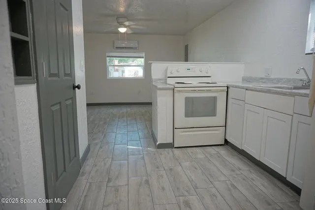 a kitchen with a stove oven and white cabinets