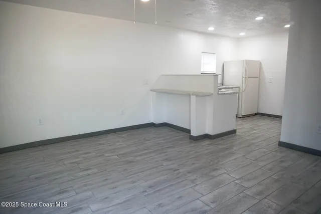 a view of a kitchen with wooden floor