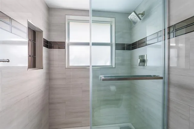 a bathroom with a glass shower door