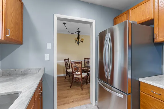 a metallic refrigerator freezer sitting in a kitchen