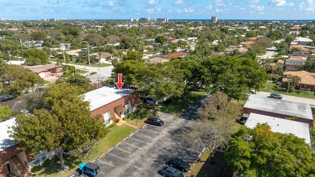 an aerial view of residential houses with city view