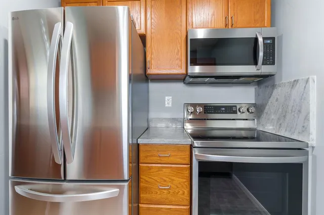 a stove top oven sitting inside of a kitchen