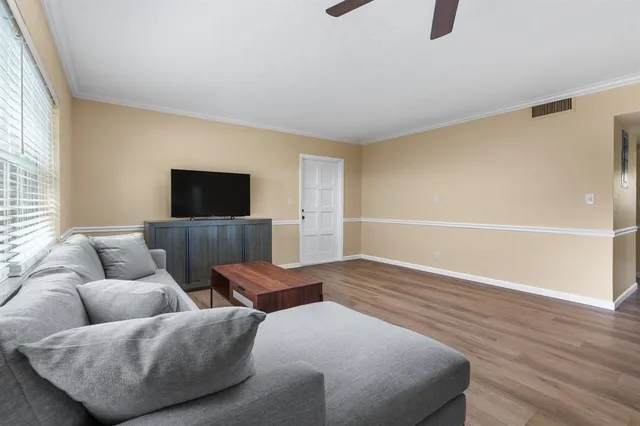 a patio with table and chairs and potted plants