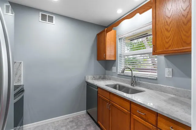 a kitchen with a sink and a window