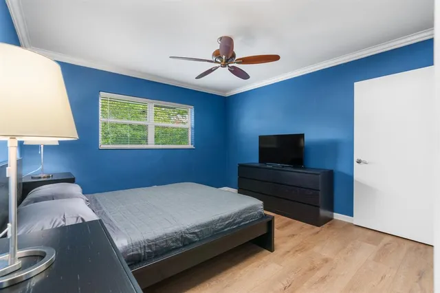 a bedroom with a bed and a lamp