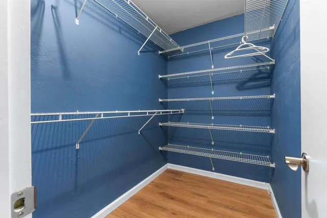 a view of walk in closet with empty racks