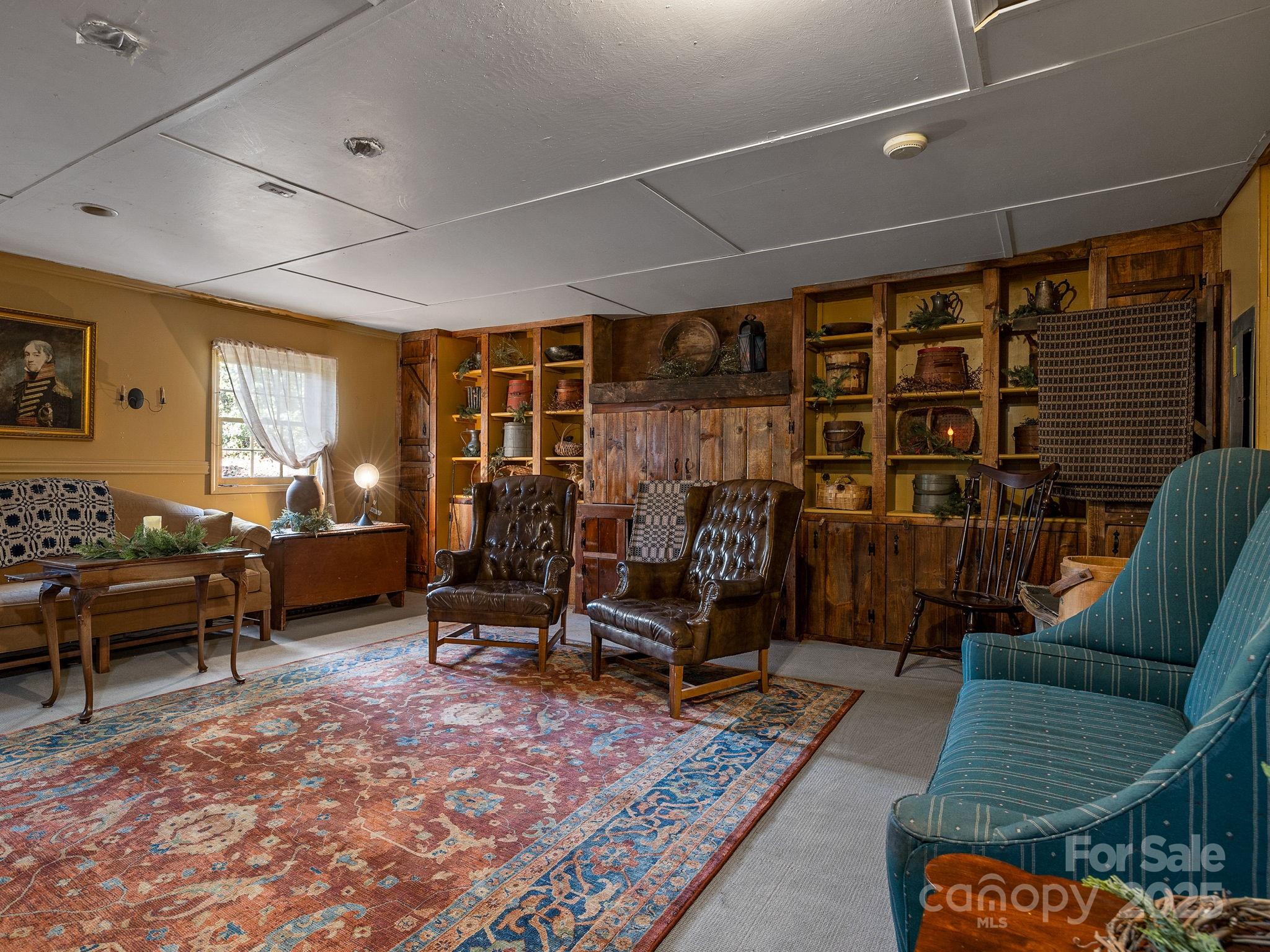 1933 John Shehan Road Mill Spring, NC 28756 - Photo 13 of 25 a living room with furniture a rug and gym equipment