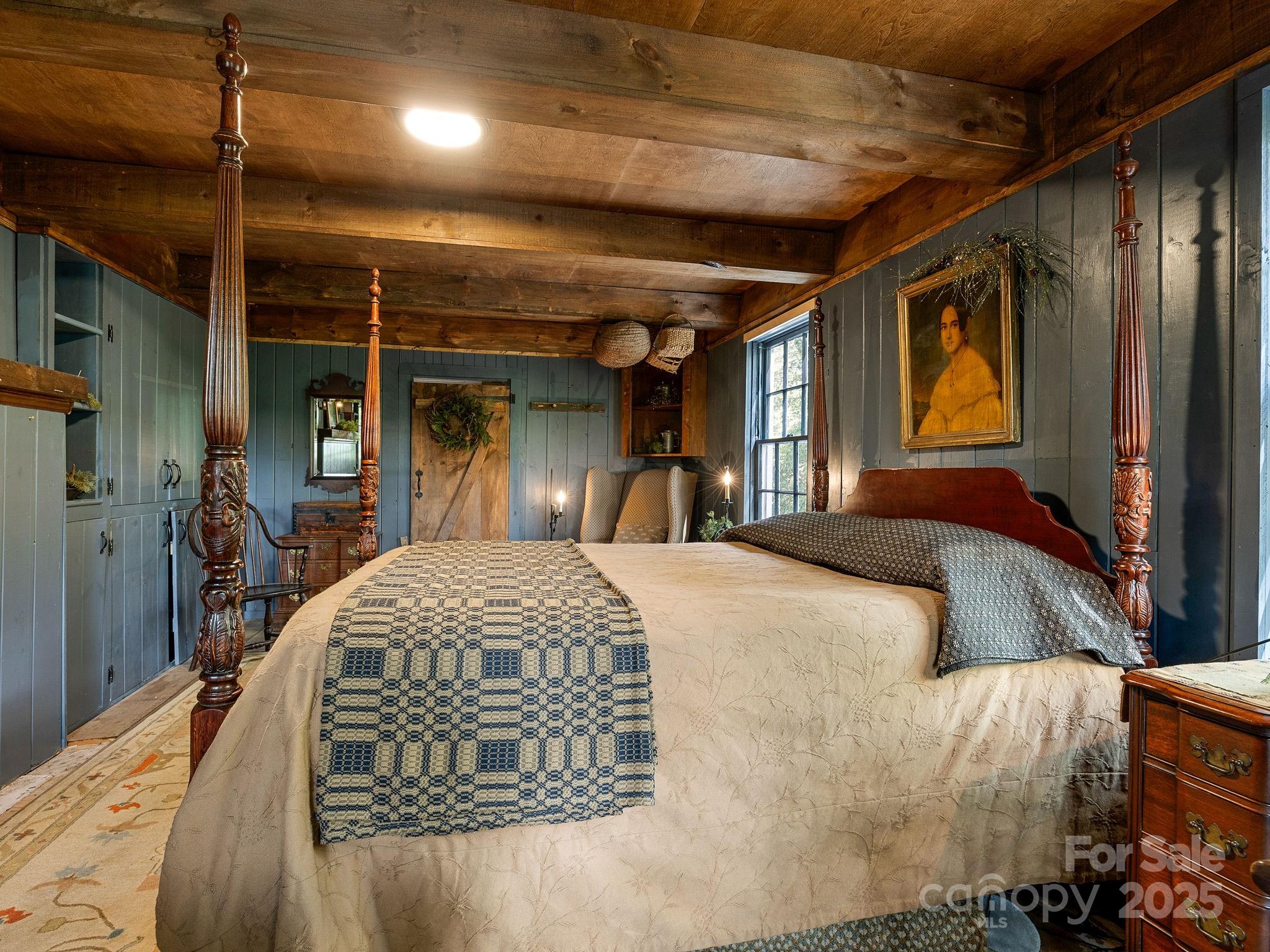 1933 John Shehan Road Mill Spring, NC 28756 - Photo 16 of 25 a bed room with a bed and a large mirror