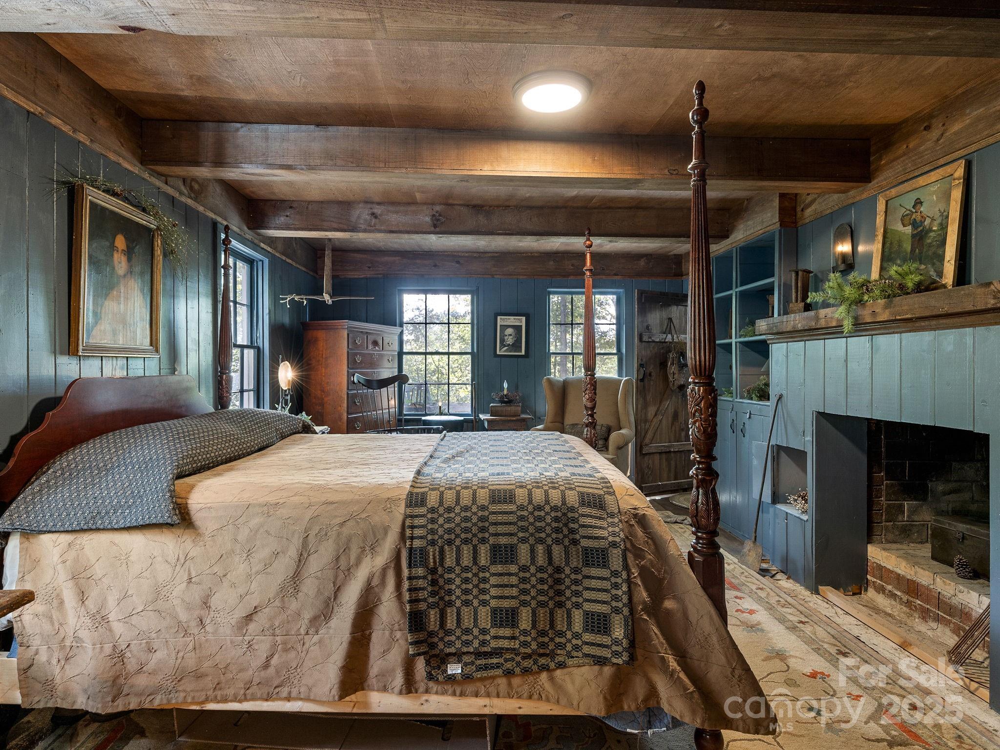 1933 John Shehan Road Mill Spring, NC 28756 - Photo 17 of 25 a bed sitting in a room next to a fireplace