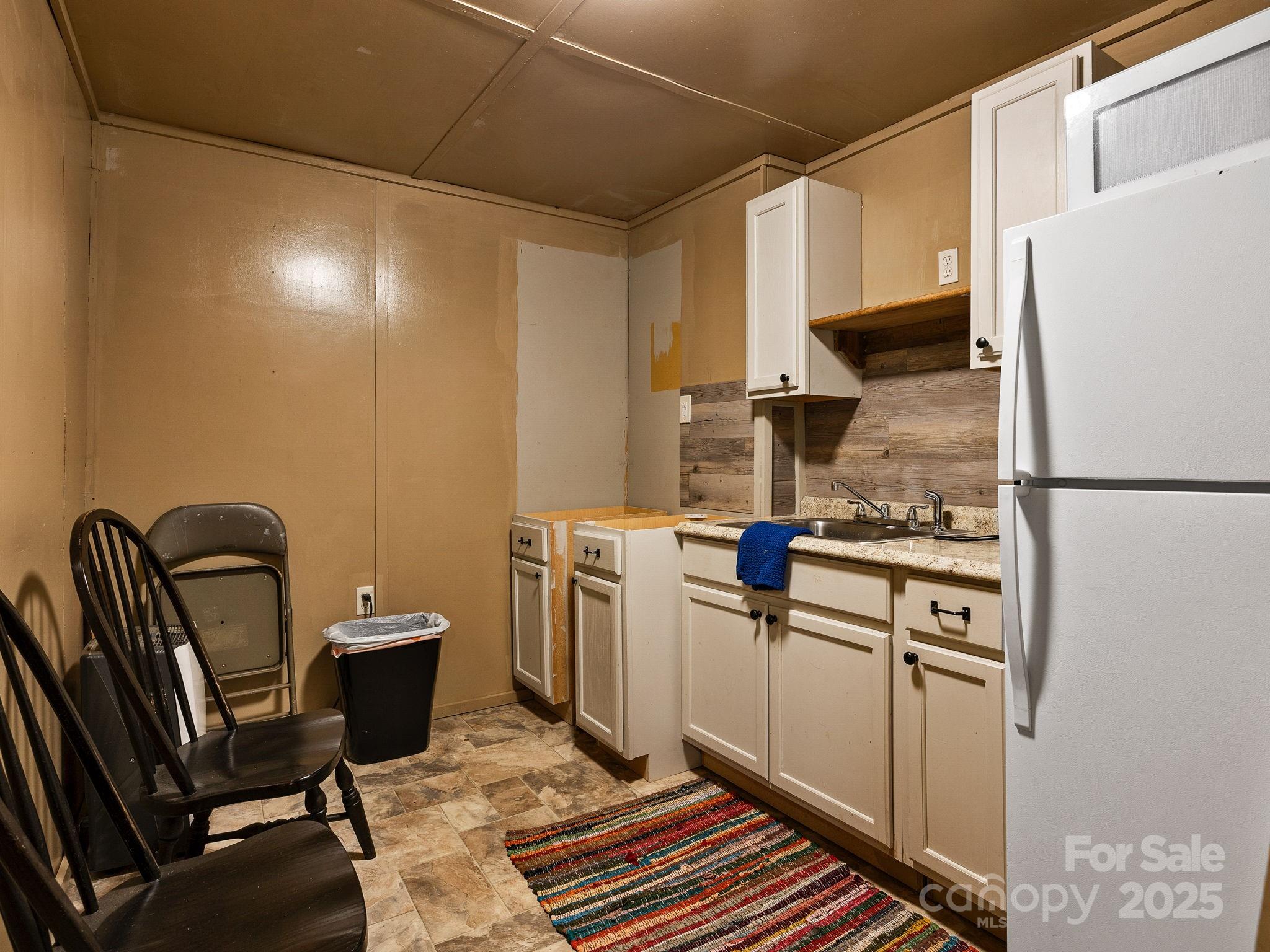 1933 John Shehan Road Mill Spring, NC 28756 - Photo 20 of 25 a kitchen with a refrigerator and a stove top oven