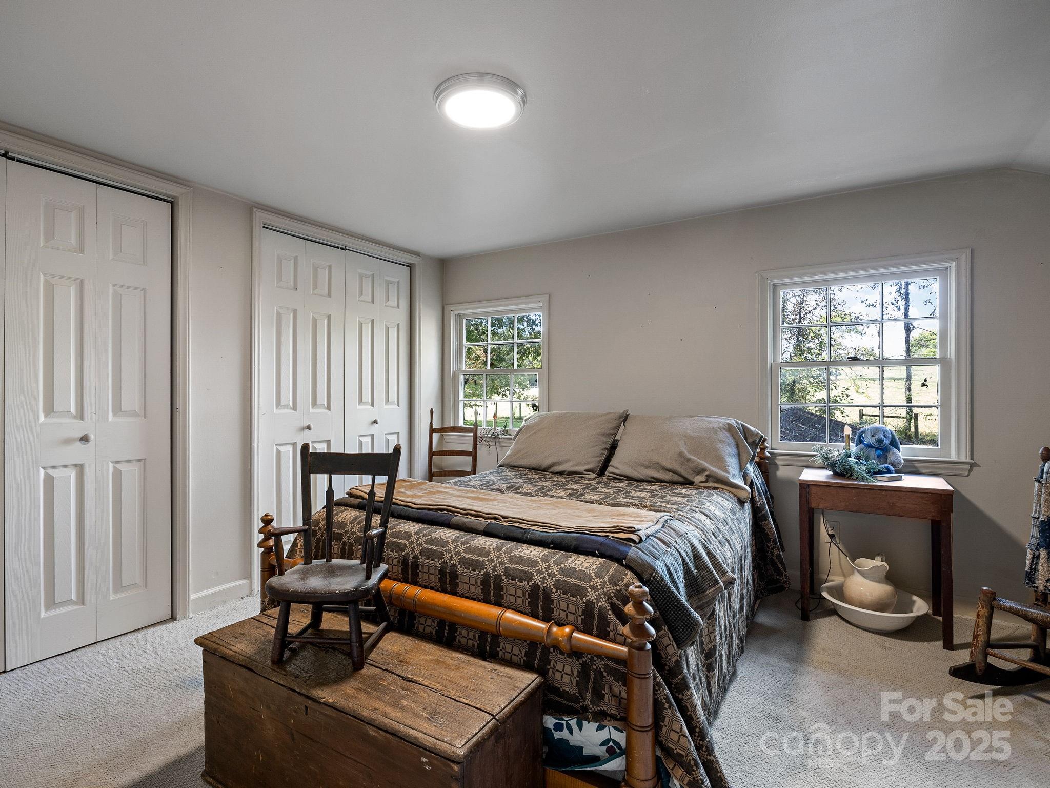 1933 John Shehan Road Mill Spring, NC 28756 - Photo 21 of 25 a bed room with a bed and a chair