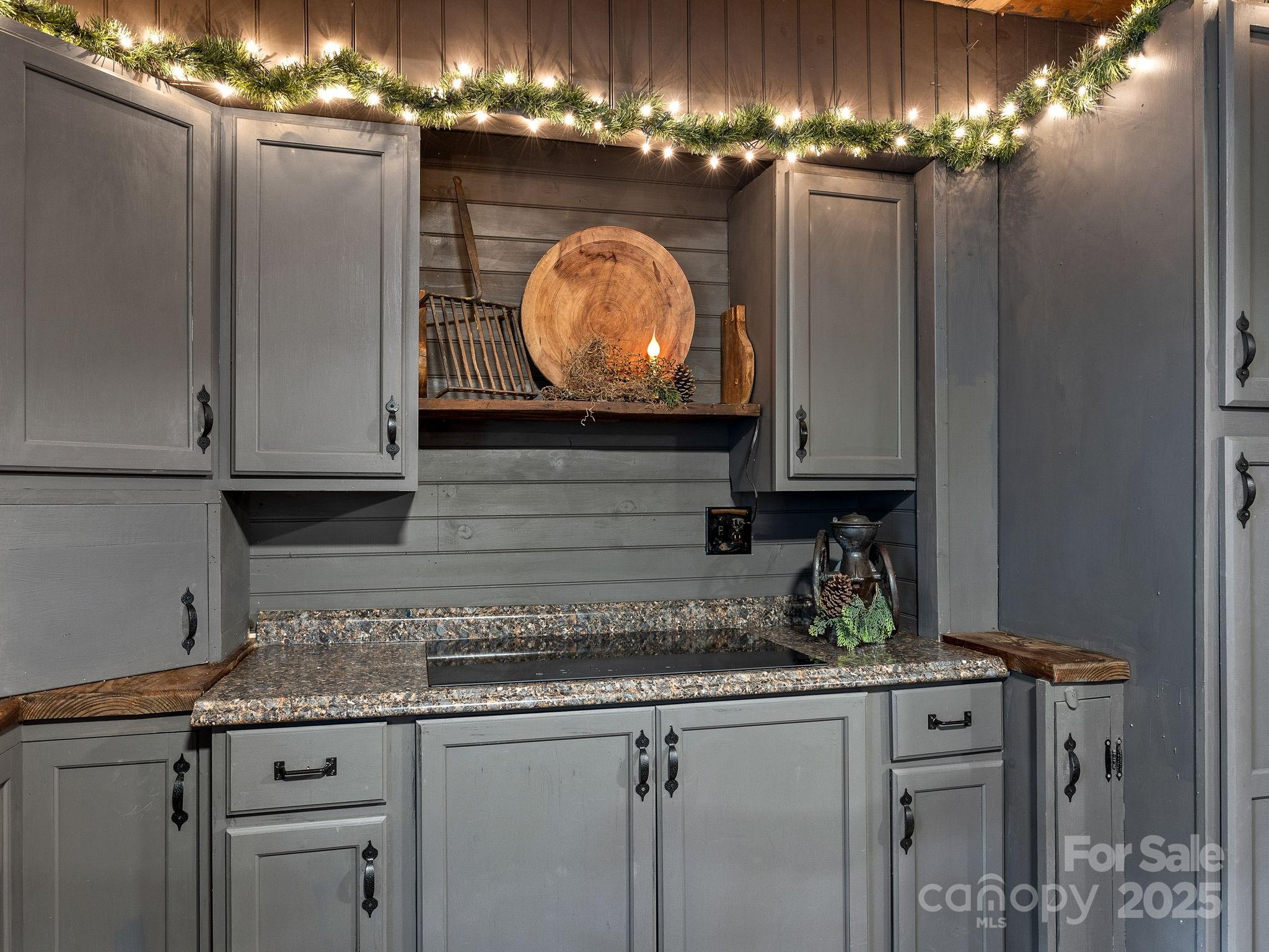 1933 John Shehan Road Mill Spring, NC 28756 - Photo 9 of 25 a kitchen with cabinets and chandelier