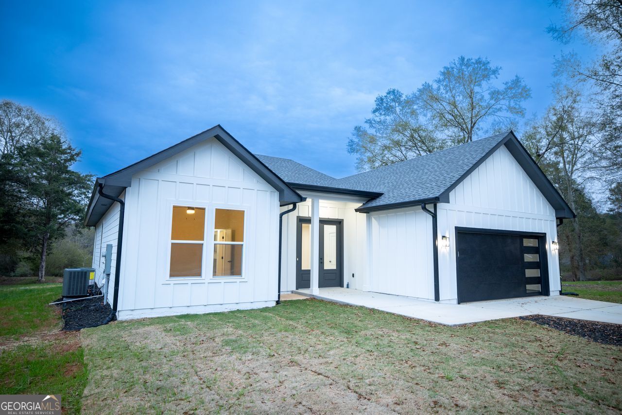 2590 Walton Downs Road, Unit 3 Monroe, GA 30655 - Photo 1 of 37 a view of a house with a yard and garage