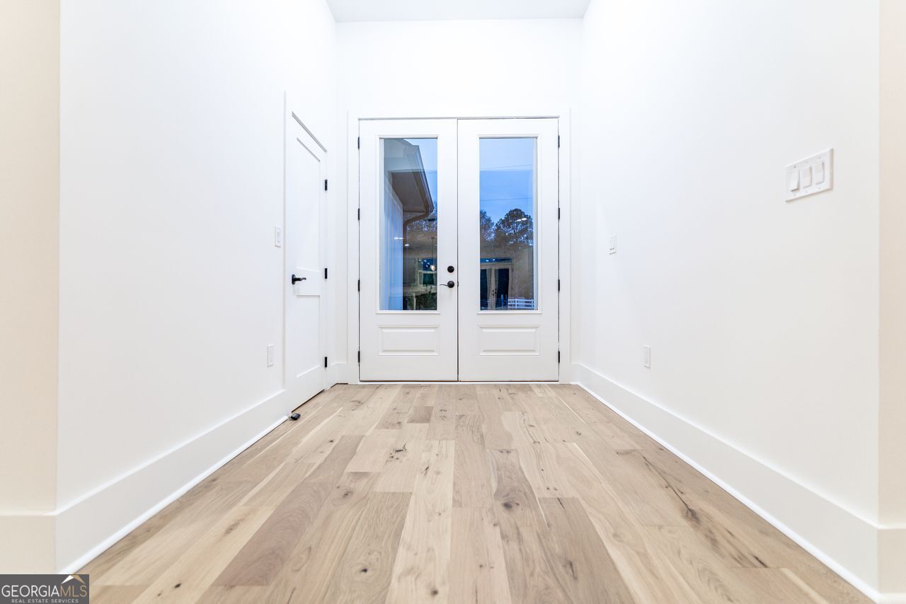 2590 Walton Downs Road, Unit 3 Monroe, GA 30655 - Photo 12 of 37 a view of an empty room with wooden floor