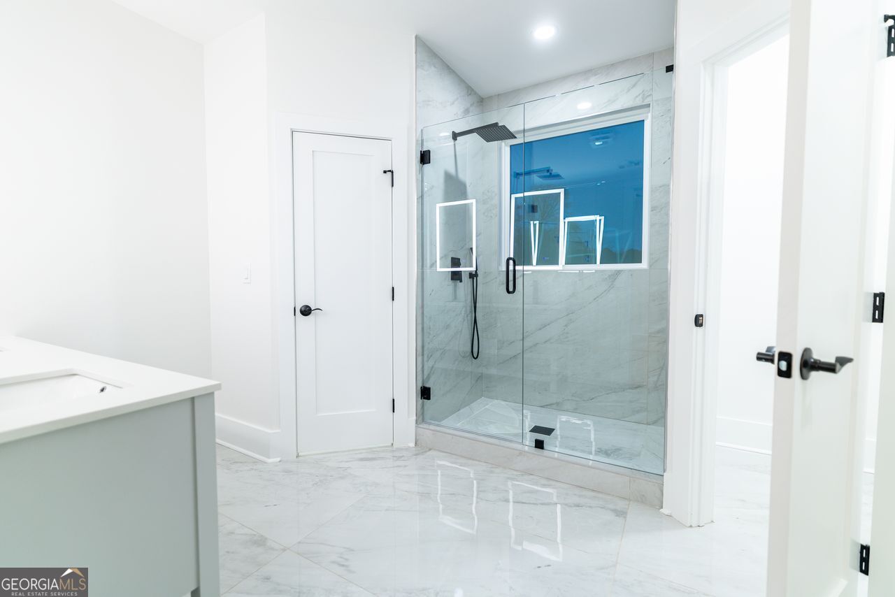2590 Walton Downs Road, Unit 3 Monroe, GA 30655 - Photo 13 of 37 a bathroom with a shower a toilet and a sink