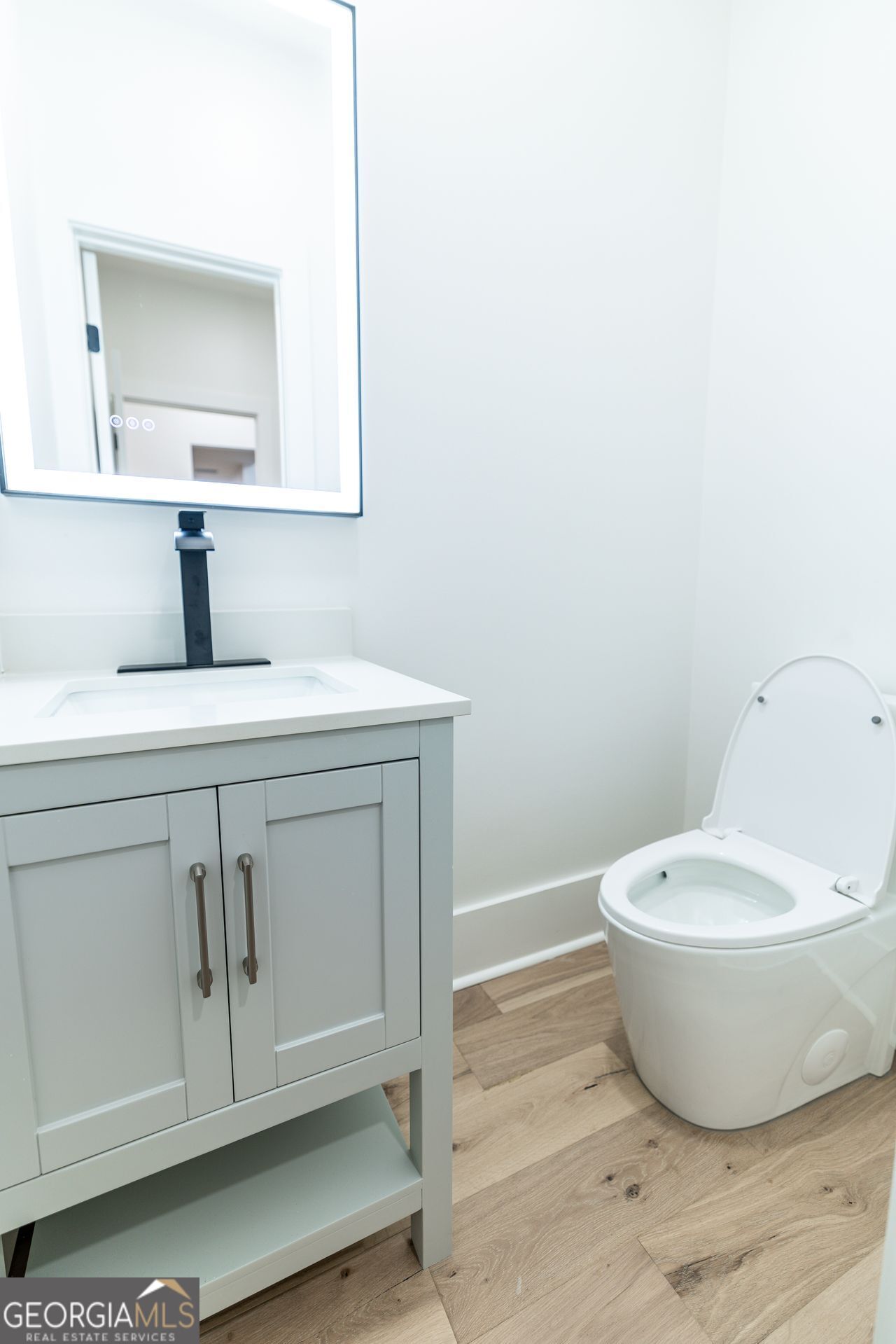 2590 Walton Downs Road, Unit 3 Monroe, GA 30655 - Photo 16 of 37 a bathroom with a toilet sink and mirror