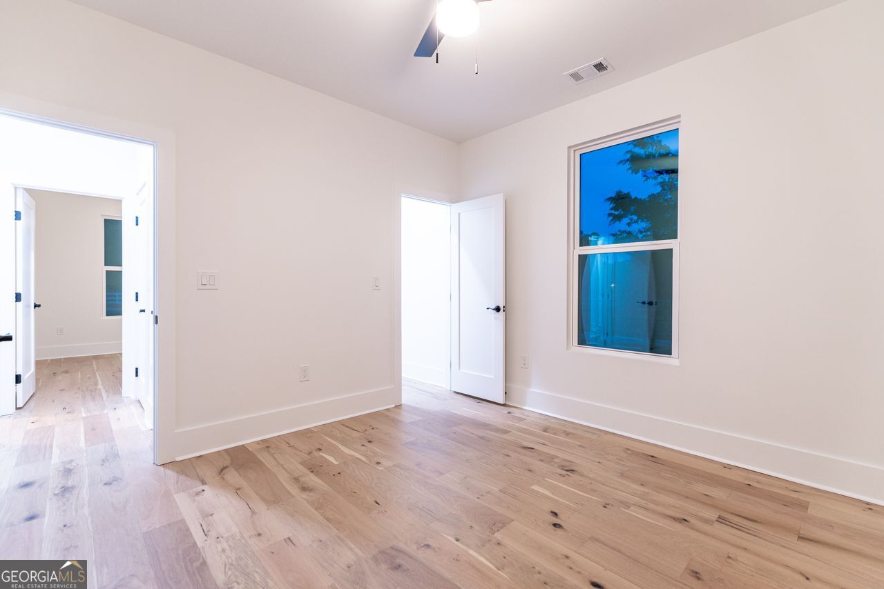 2590 Walton Downs Road, Unit 3 Monroe, GA 30655 - Photo 23 of 37 wooden floor in an empty room with a window