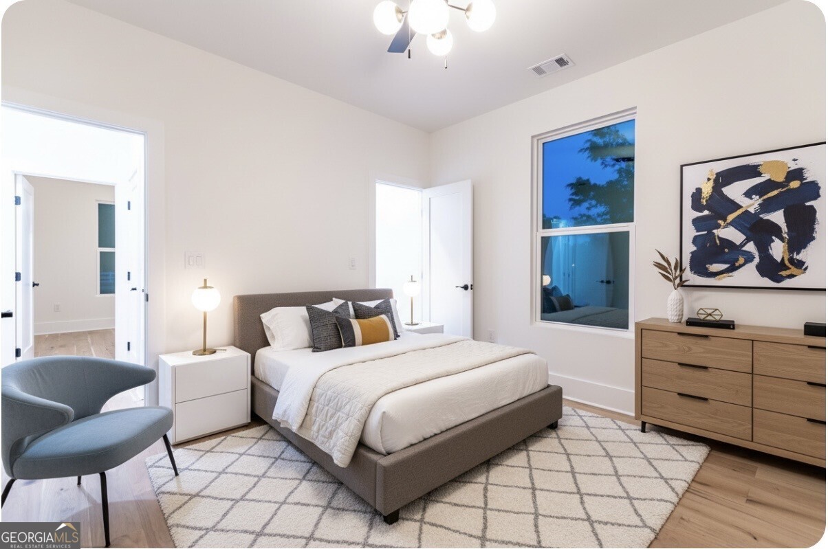 2590 Walton Downs Road, Unit 3 Monroe, GA 30655 - Photo 24 of 37 a bedroom with a bed and a chair