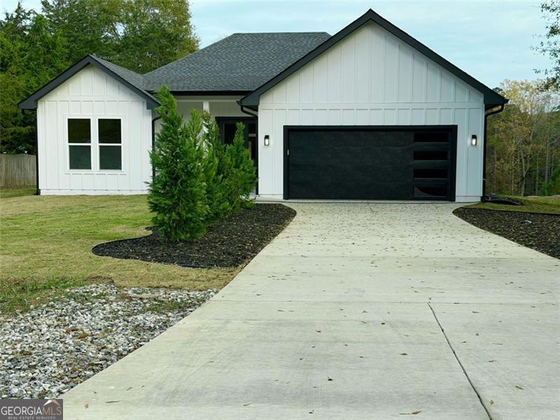 2590 Walton Downs Road, Unit 3 Monroe, GA 30655 - Photo 4 of 37 a front view of a house with a yard and garage