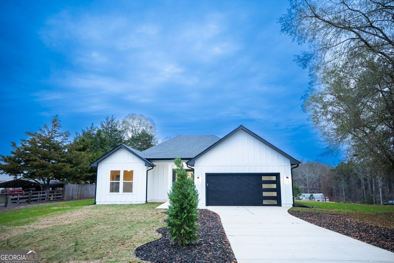 2590 Walton Downs Road, Unit 3 Monroe, GA 30655 - Photo 5 of 37 a front view of a house with a yard and garage