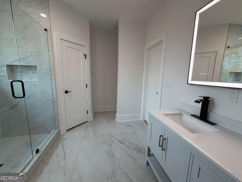 2590 Walton Downs Road, Unit 3 Monroe, GA 30655 - Photo 6 of 37 a bathroom with a sink and mirror